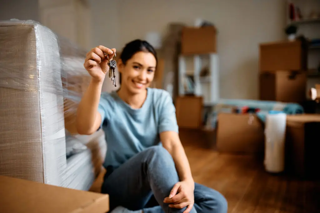 First-time home buyer holding the keys to a new apartment
