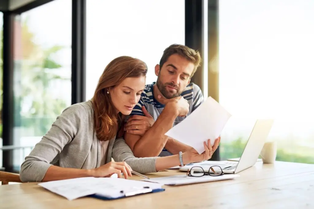 Couple reviewing mortgage documents together at home