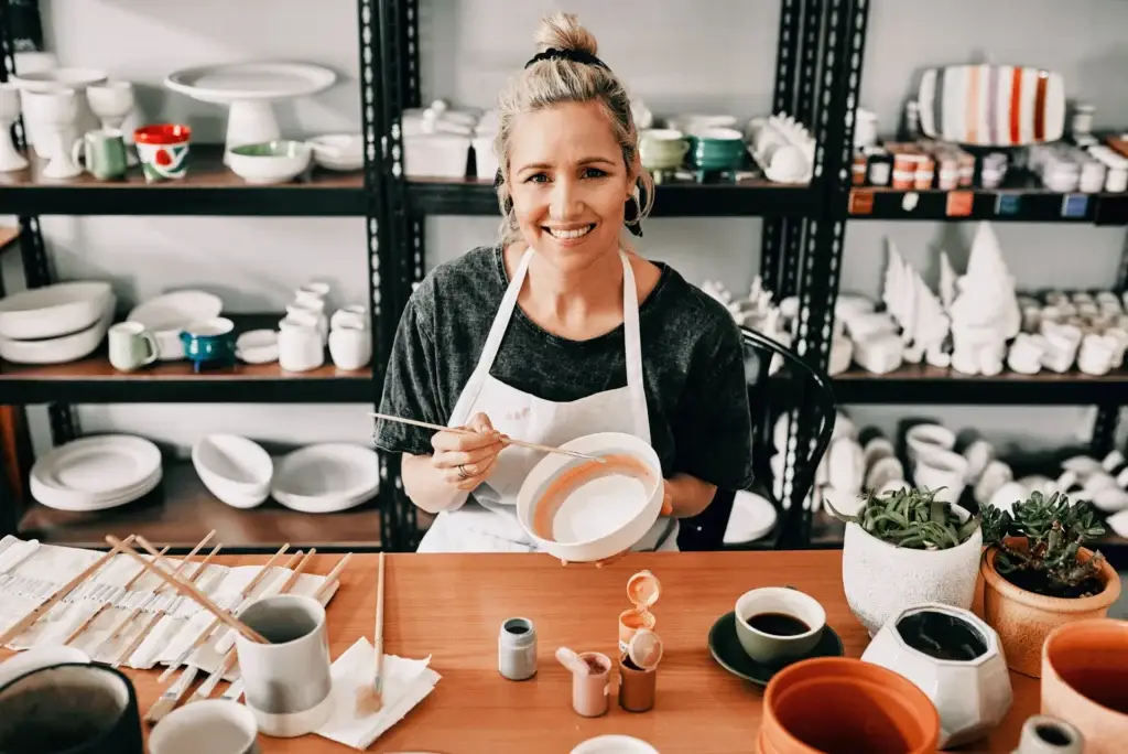 Self-employed ceramic artist working in her studio